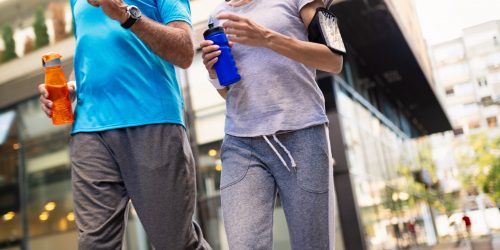 Fitness, sport, people, exercising and lifestyle concept - mature couple running