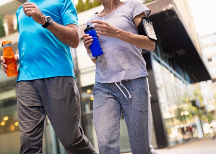 Fitness, sport, people, exercising and lifestyle concept - mature couple running